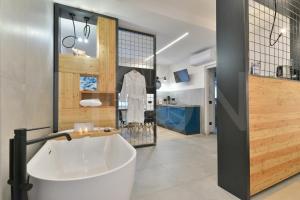 a bathroom with a white tub in a room at Le Lion Apartments - Bike & Ski in Aosta
