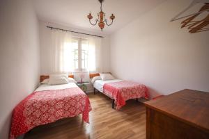 1 dormitorio con 2 camas y ventana en Maria La Franca, en La Franca