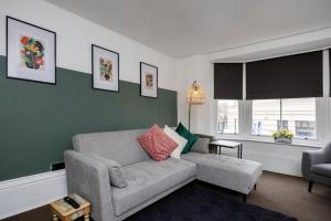 a living room with a couch and a window at Central 2 bedroom flat in the heart of the lanes in Brighton & Hove