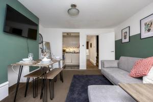 a living room with a couch and a table at Central 2 bedroom flat in the heart of the lanes in Brighton & Hove
