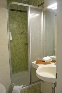 a bathroom with a shower and a sink at Residenz Hotel Leipzig in Leipzig