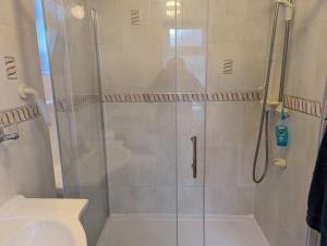 a bathroom with a shower with a toilet and a sink at House in Leeds