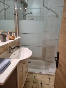 a bathroom with a sink and a shower at Hotel Bellevue in Ayse