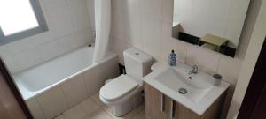 uma casa de banho branca com um WC e um lavatório em Magua Home: Apartment at 25 meters from Canteras beach em Las Palmas de Gran Canaria