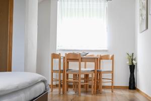 a dining room table and chairs in front of a window at Guesthouse Rubcic in Rakovica