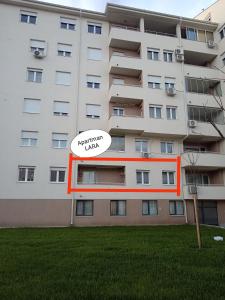 an apartment building with a sign that reads apartment units at Apartman LARA in Pirot