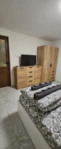 a bedroom with two beds and a flat screen tv at Ново ! Апартамент Dreams 1 in Sliven