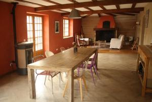 a dining room with a table and chairs and a fireplace at Le clos Darwin - chambres d'hôtes in Brin-sur-Seille