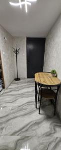 a room with a table and a plant on the floor at Ново ! Апартамент Dreams 1 in Sliven