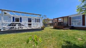 a mobile home with a porch and a yard at Muntagn' home in Corte