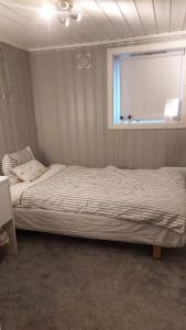 a bedroom with a bed and a window in it at Room close to city centre and beach in Oslo