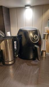 a black toaster sitting on top of a table at Room close to city centre and beach in Oslo