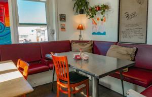 a dining room with a table and a couch at ITH Los Angeles Beach Hostel in Hermosa Beach