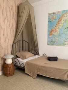 a bedroom with two beds and a map on the wall at La Soissonnaise, maison de ville à Soissons in Soissons