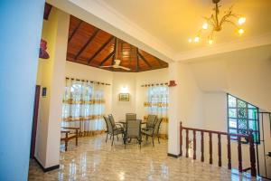 a dining room with a table and chairs at Villa Sun Grace in Galle