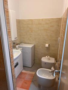 a bathroom with a toilet and a sink at Casa Francesca in Albissola Marina