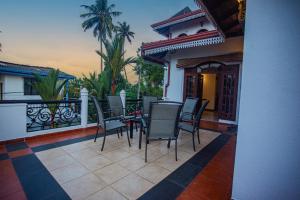 a patio with chairs and a table on a balcony at Villa Sun Grace in Galle