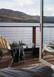a room with a view of a body of water at Shoreland Lodges - Cherry Lodge in Fort Augustus