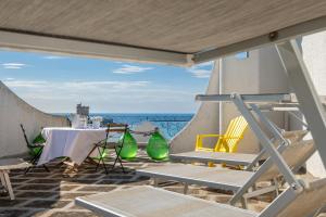 a table and chairs on a patio with a view of the ocean at Villa Gaudì - Mallorca in Sant'Isidoro