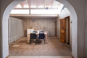 a dining room with an archway and a table and chairs at Villa Gaudì - Mallorca in Sant'Isidoro +9 photos