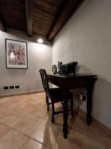 a desk in a room with a chair and a cat sitting at it at La Grangia in Giaveno +26 photos