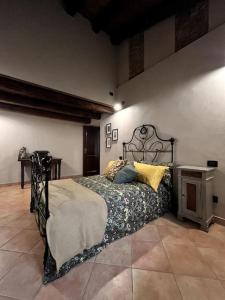 a bedroom with a bed with a metal bed frame at La Grangia in Giaveno