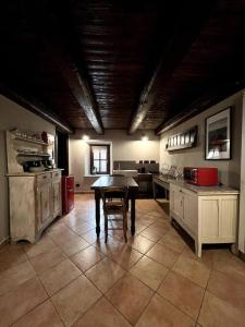a kitchen with a table in the middle of a room at La Grangia in Giaveno