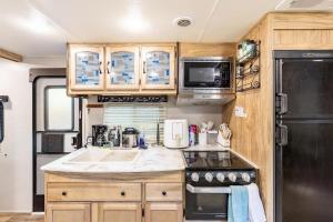 an rv kitchen with a sink and a refrigerator at The Great Escape in Fort Worth