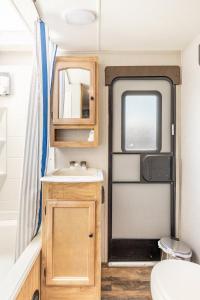 a bathroom with a sink and a toilet in a caravan at The Great Escape in Fort Worth
