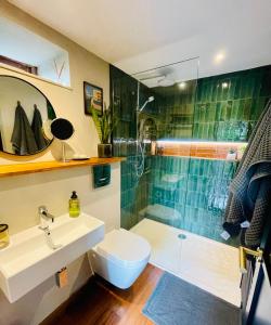a bathroom with a sink and a shower and a toilet at The Hideaway Apartment, Bath in Bath