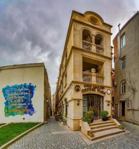 a building with a balcony on a street at Coffee time hotel in Baku