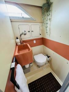 a small bathroom with a toilet and a sink at Cosy and Homey Houseboat Castelldefels in Barcelona