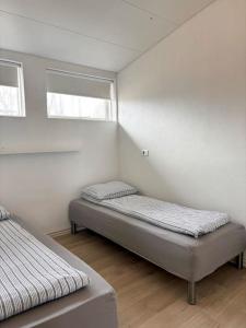 a room with two beds and a window at Selfoss Center apartment in Selfoss