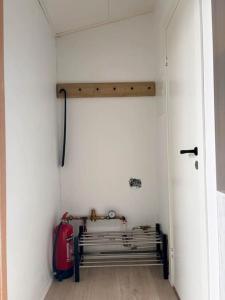 a hallway with a bench in a white wall at Selfoss Center apartment in Selfoss