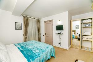 a bedroom with a bed and a tv and a mirror at Coffee time hotel in Baku