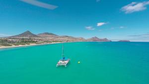 a boat in the middle of a large body of water at Vila Baleira Porto Santo in Porto Santo
