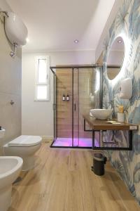 a bathroom with a shower and a toilet and a sink at Cuore Napoli Centro in Naples