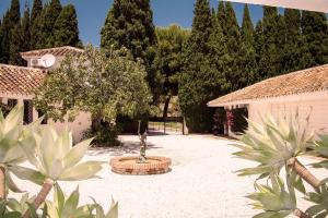 a courtyard with a tree in the middle of a yard at 7,000 sqm Luxurious Villa with Panoramic Sea Views Multiple Gardens & Two Pools in Benalmádena +112 photos