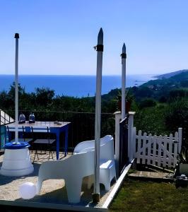 a patio with a table and a white fence at La collina sui trabocchi in Ortona