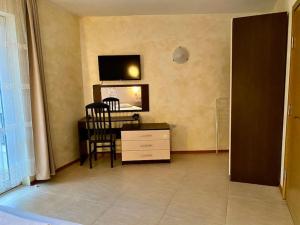 a living room with a desk and a chair and a tv at “Sunny Beach Hills” Apartment B2.8 in Sunny Beach