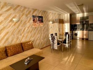 a living room with a couch and a table with chairs at “Sunny Beach Hills” Apartment B2.8 in Sunny Beach