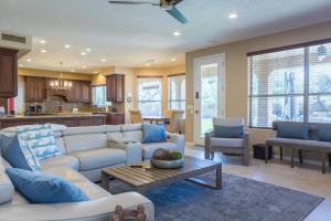 a living room with a couch and a table at Desert Paradise Pool Spa Pickleball Putt Green in Phoenix