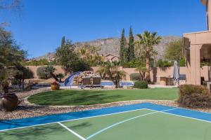 a tennis court in front of a house at Desert Paradise Pool Spa Pickleball Putt Green in Phoenix