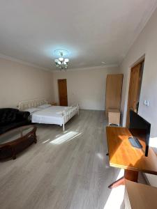a large room with two beds and a desk at your home in Batumi in Batumi