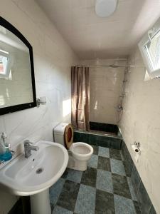 a bathroom with a sink and a toilet at your home in Batumi in Batumi