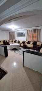 a large living room with couches and a table at Super Cozy Apartment in Larache