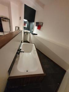 a bathroom with a white sink in a room at Maison de campagne in Amponville