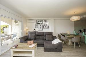 a living room with a couch and a table at Casa con bonitas vistas en Montjuic Girona in Girona