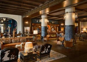 a living room with couches and chairs and tables at Bowie House, Auberge Collection in Fort Worth