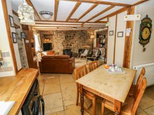 a kitchen and living room with a table and chairs at 1 Mill Farm Cottages in Narberth